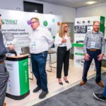 Delegates talking to exhibitors at a trade exhibition