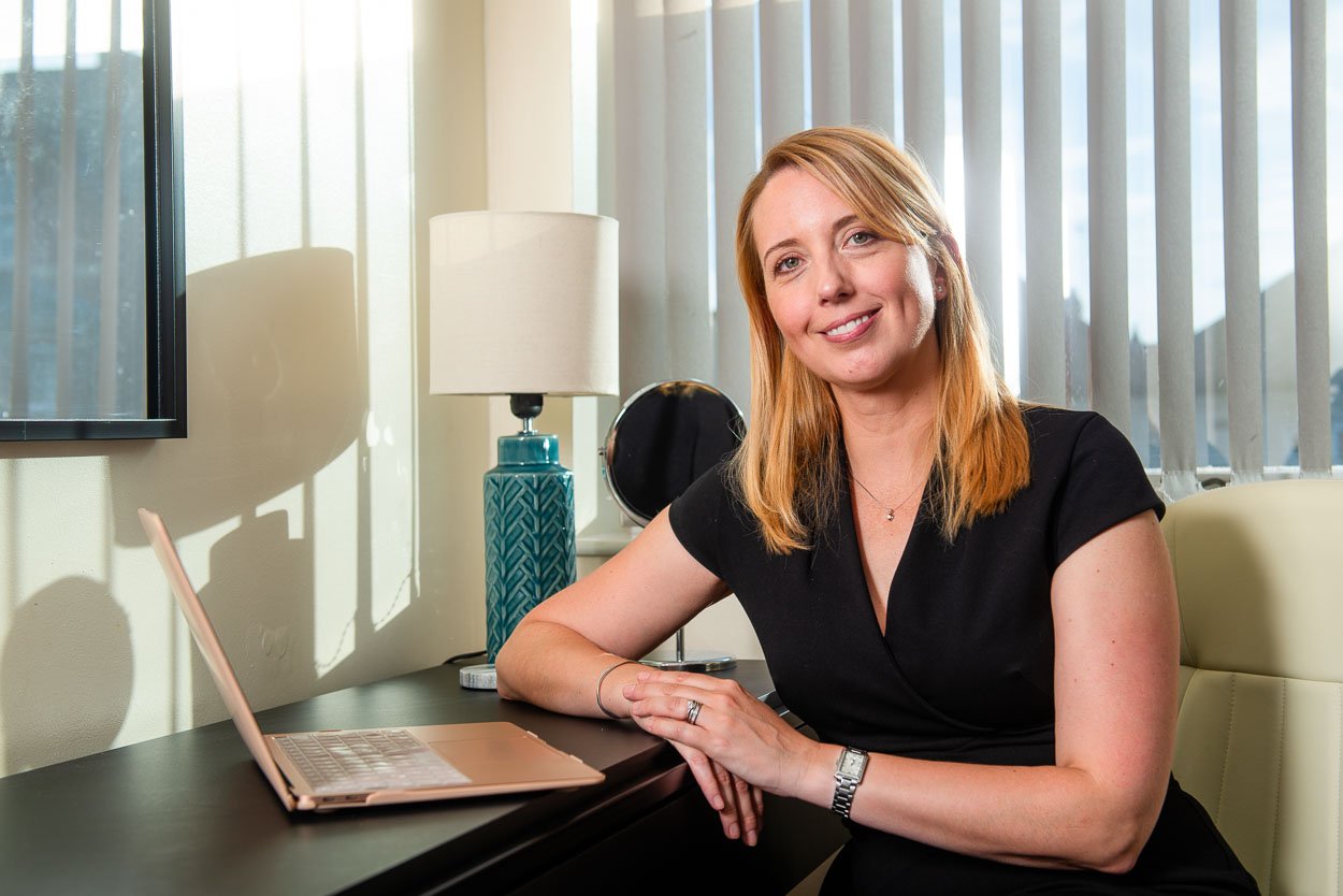 Portrait photograph - female professional seated with laptop