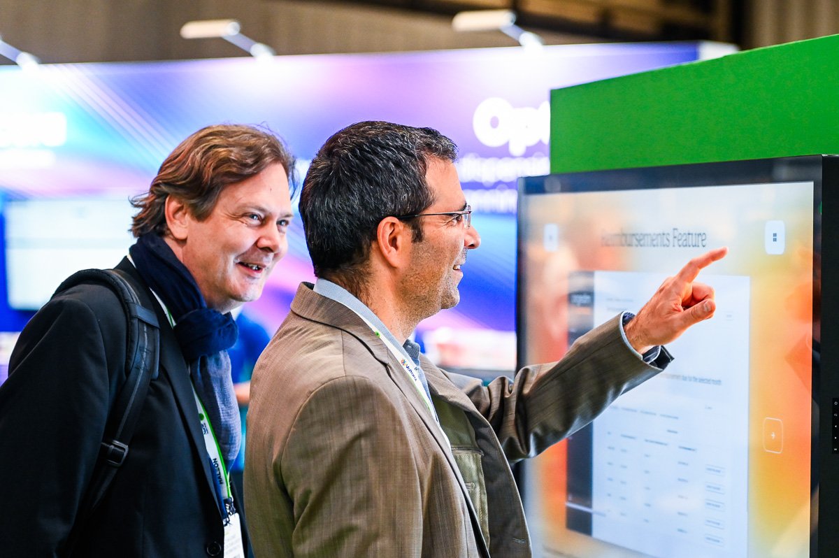 Visitors interacting with a touch screen at a trade show, NEC, Birmingham