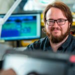 Portrait of electronic engineer in workplace, London
