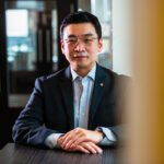 Portrait photograph, seated Korean businessman