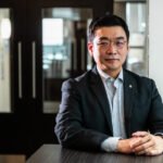 Portrait photograph, seated Korean businessman