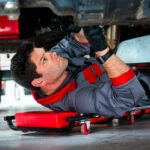 Photograph of maintenance engineer working on underside of undustrial crane