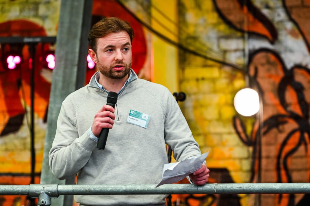 Man with microphone speaking at event in Central Birmingham