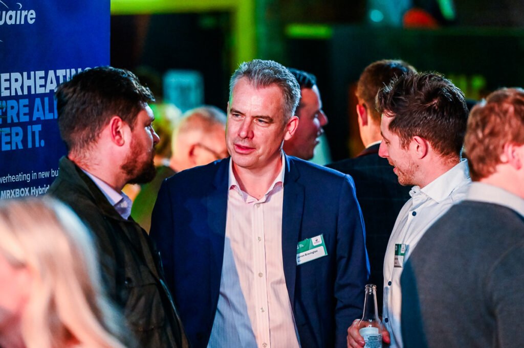 Men talking at business networking evening drinks event