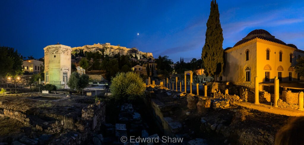 Panoramic photo at dusk of The Horologion and the Acropolis, Athens, Greece