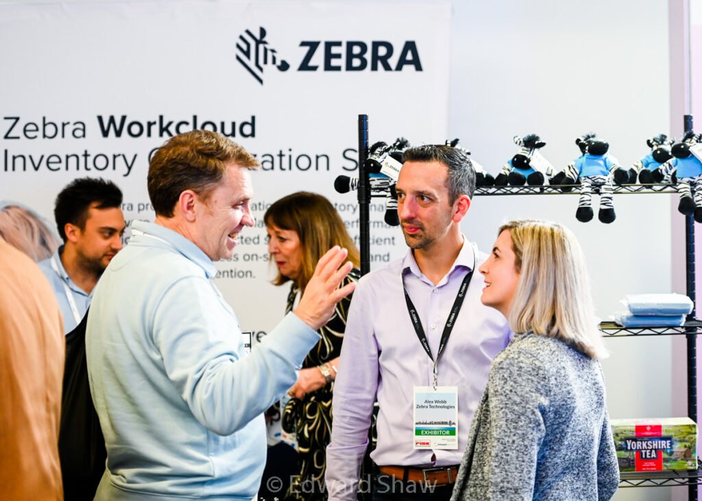 Delegates talking with exhibitors at trade show event, Leicester