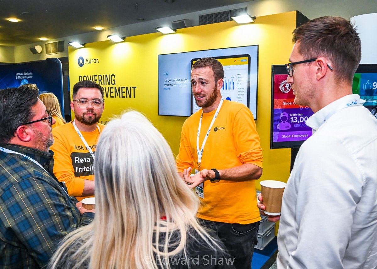 Photograph of delegates interacting with vendors at a trade show, Leicester