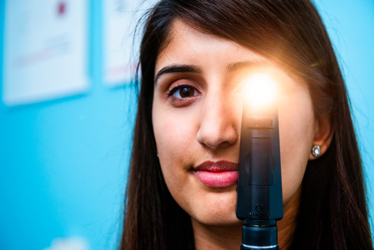 PR Photograph of opthalmologist holding eye inspection eqipment