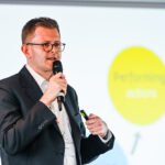 Man speaking on stage, business conference, Birmingham