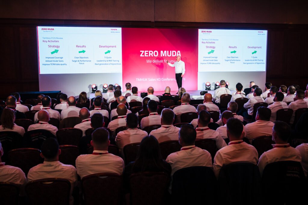 Wide angle conference photo, room and stage with speaker