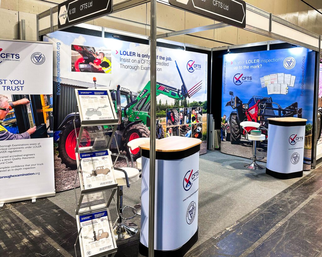 Photo - trade show stand with large display images of agricultural machinery