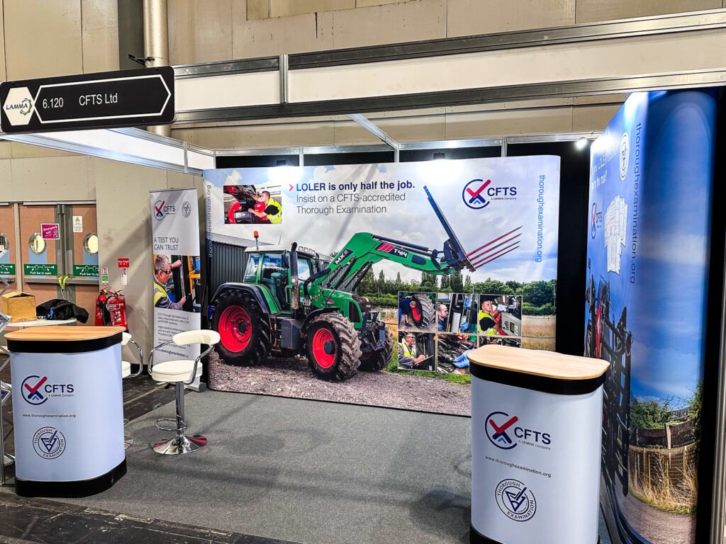 Photo - trade show stand with large display image of a tractor