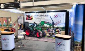 Photo - trade show stand with large display image of a tractor